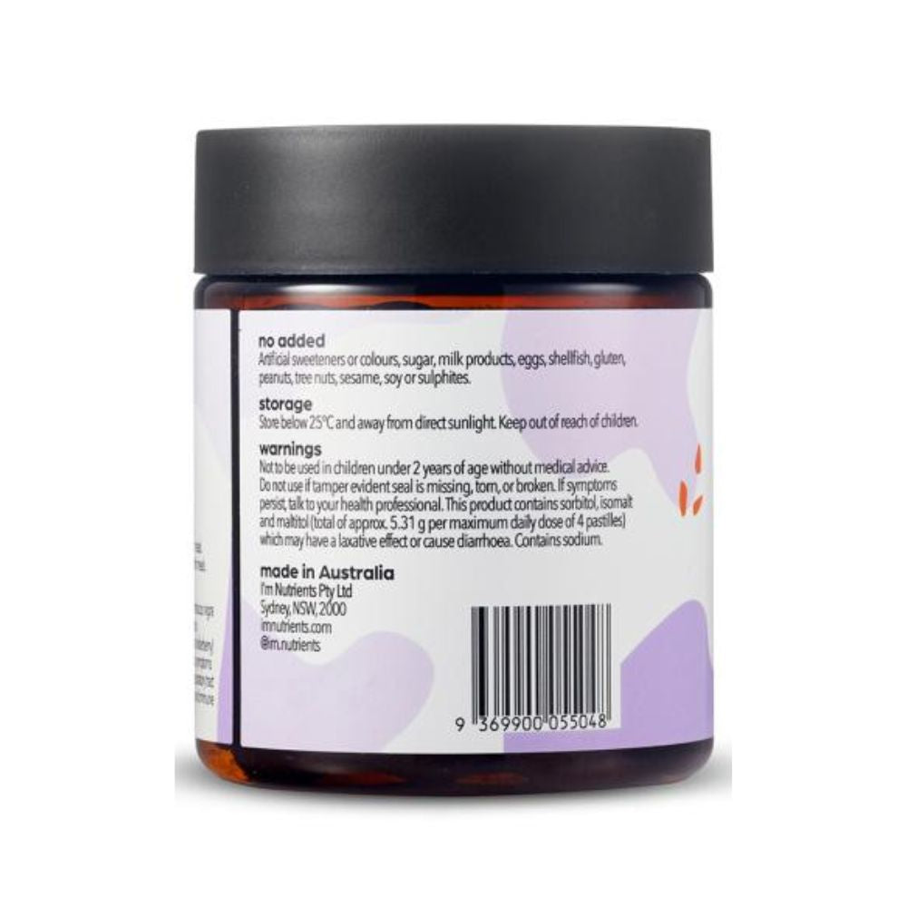 Back view of an amber glass jar with a black lid and a white label featuring light purple abstract shapes and black text, on a white background.