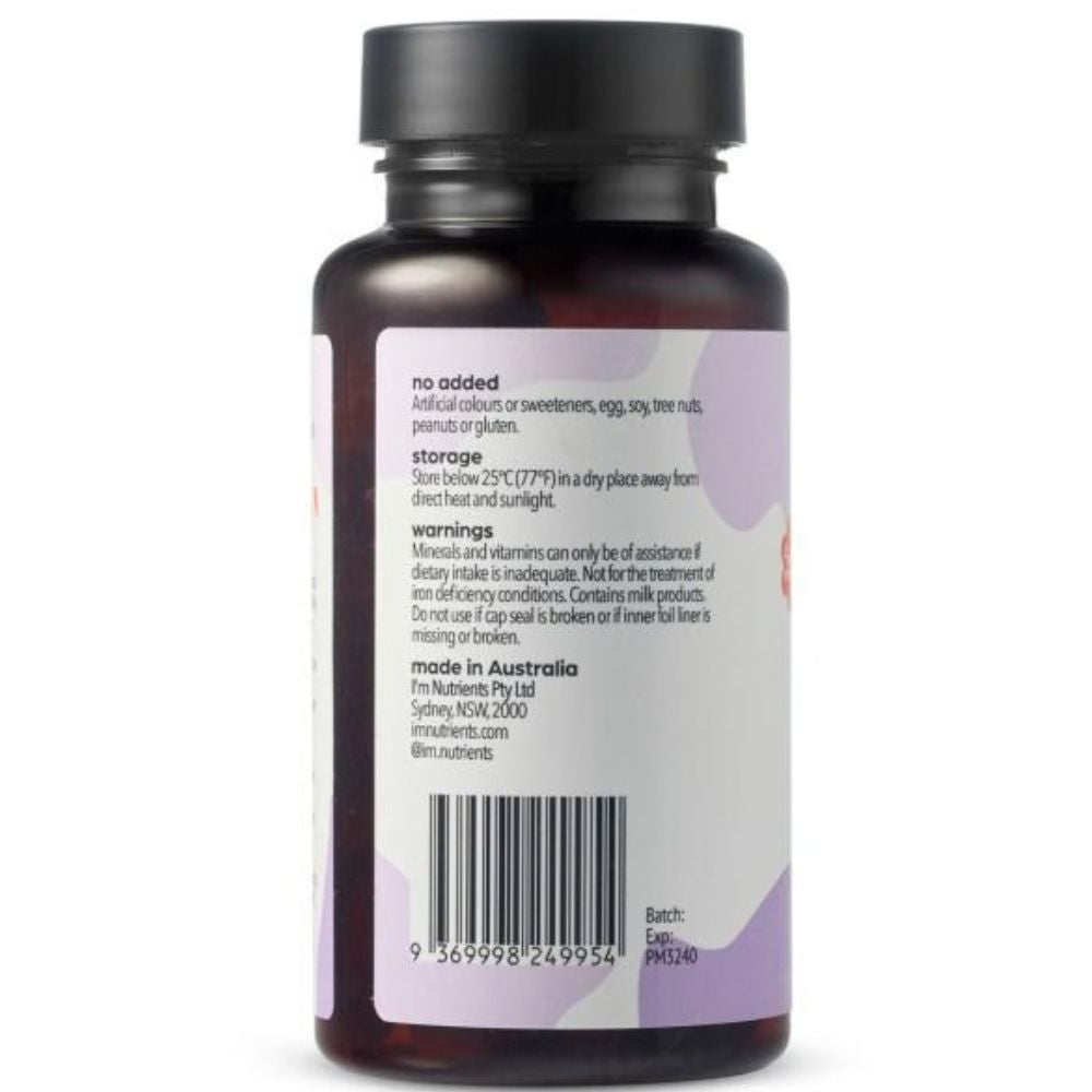 Back view of a dark amber bottle with a black cap.